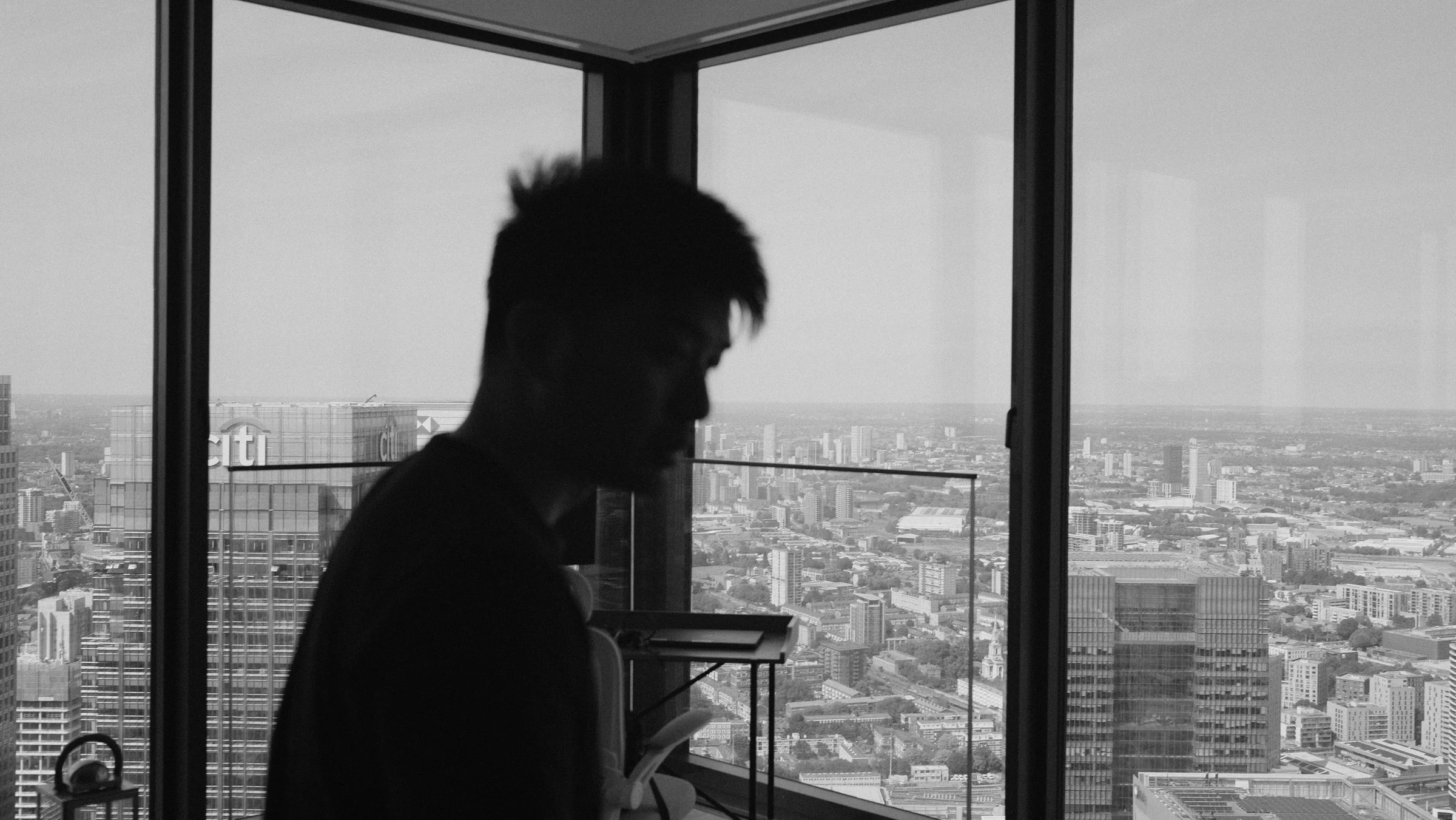 Crew member silhouetted against windows overlooking the city