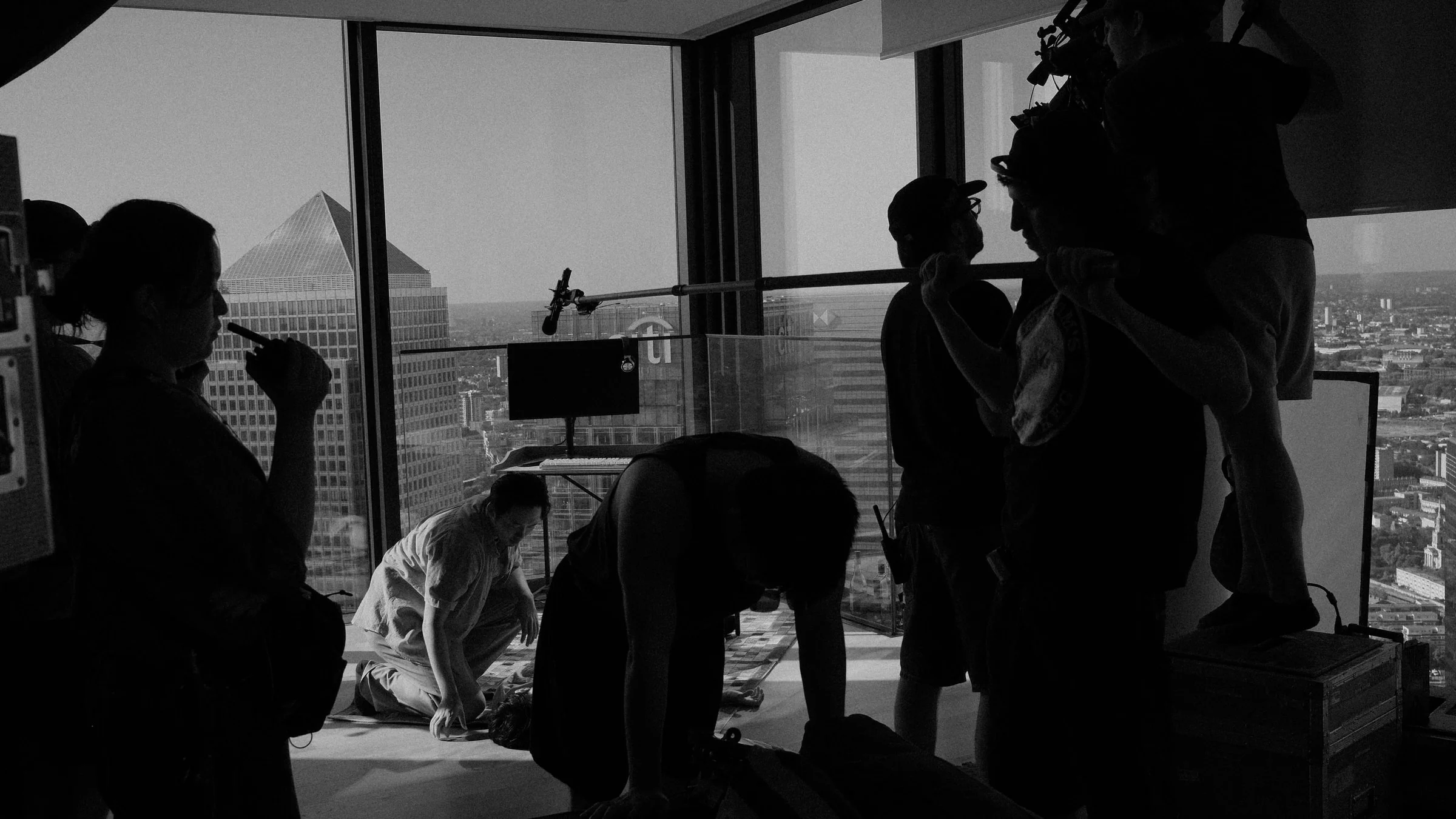 Crew preparing a wide interior setup overlooking the city