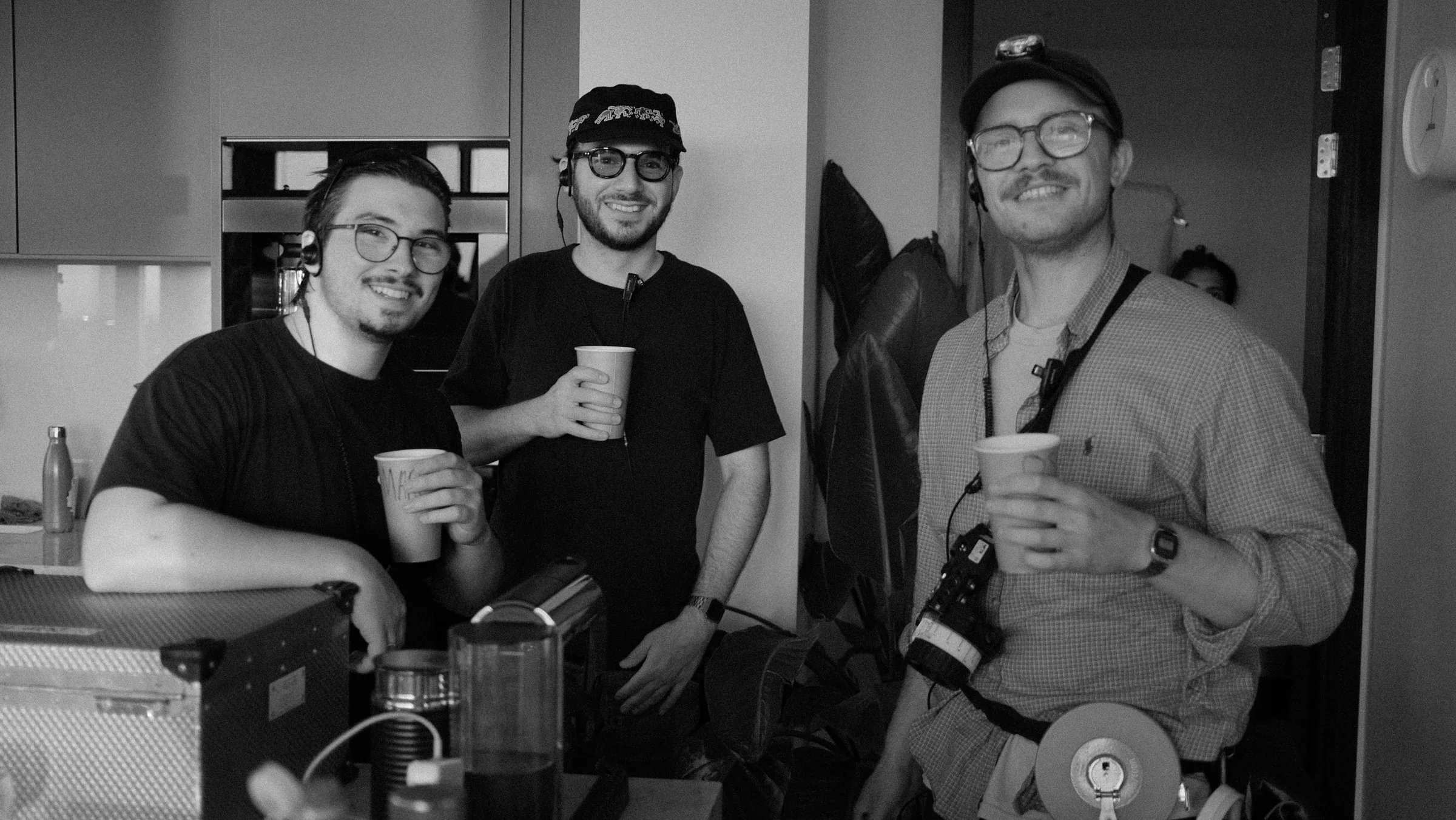 Three crew members smiling during a break